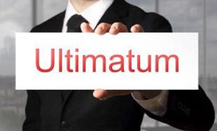 a man in a suit holding up a sign that says ulimatum